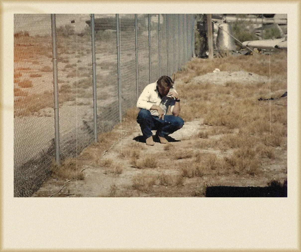 Lining up a shot along a desert fence line