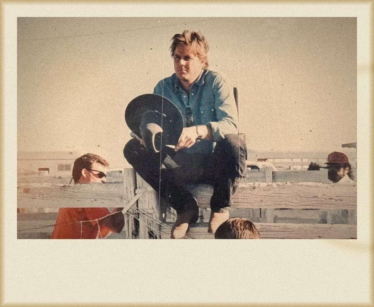 Sitting on a corral fence on the Harley Davidson and the Marlboro Man set